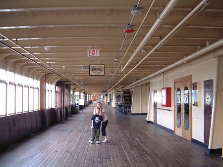 RMS Queen Mary - Port, Promenade Deck looking forward. [Chelsea Restaurant on right. Beverley & Howard]