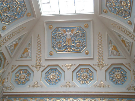 The high vaults and frieze are richly decorated with arabesque stucco.